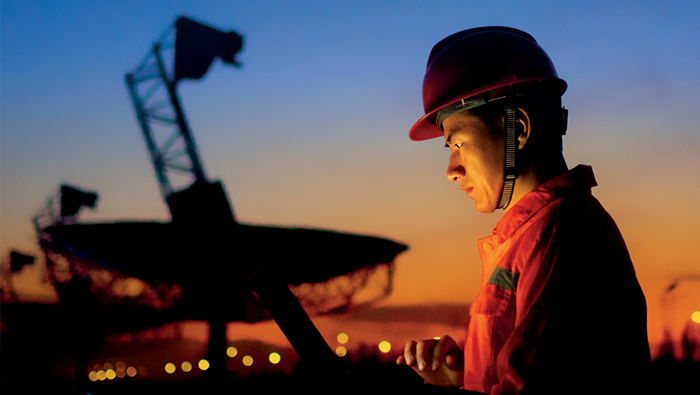A specialist wearing a hard hat working during sunset, reflecting Bell's professional services that help plan, design and deploy large-scale AI infrastructure.