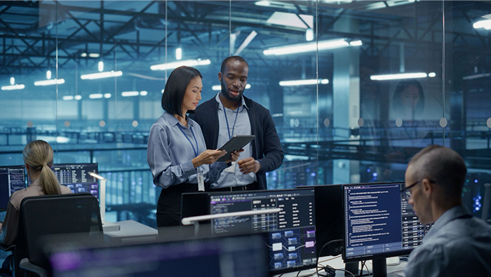 A modern security operations team monitoring digital data screens, highlighting Bell's 700+ experts who provide resilient and scalable protection.