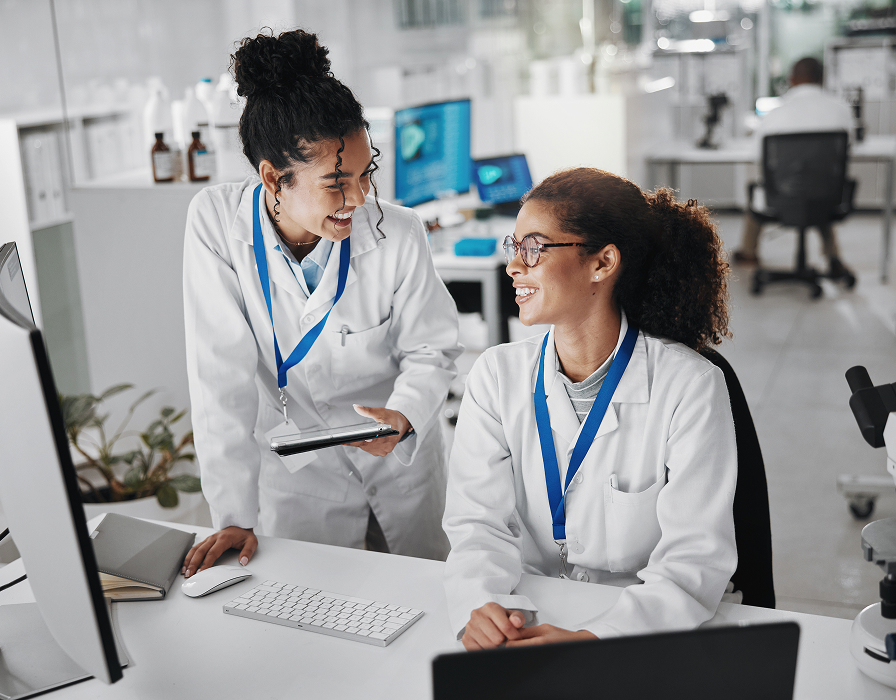 Two employees working in a healthcare facility using robust secure connectivity.